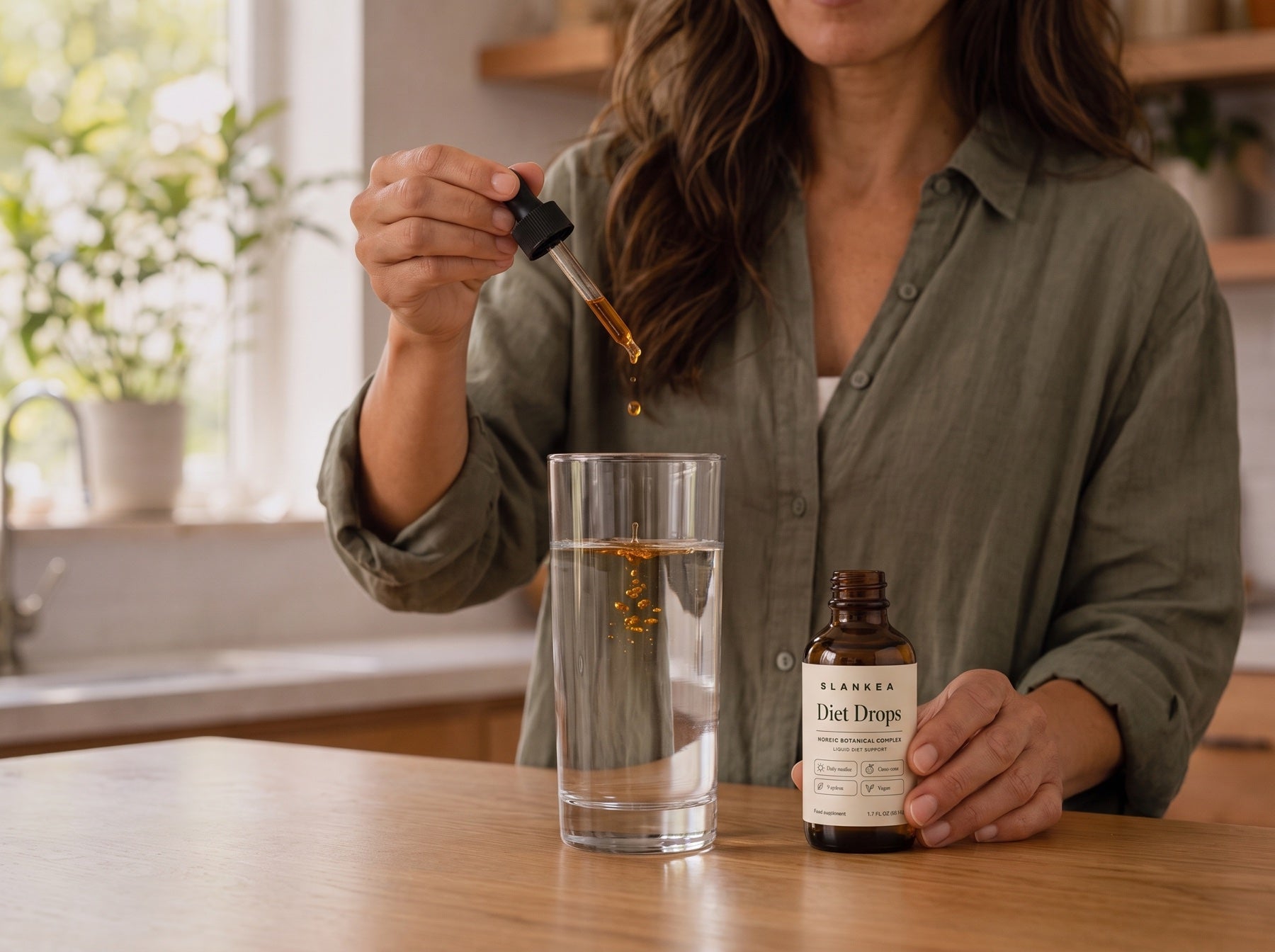 Adding the dropper to a glass of water